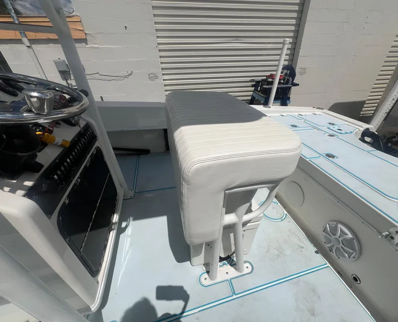 Slide: The Image of 2007 Young Boats Young 24 interior with steering console and cushioned seat. - 17