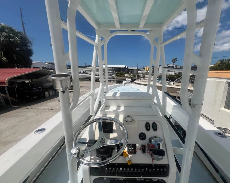 Slide: The Image of Center console of 2007 Young Boats Young 24, featuring steering wheel and gauges. - 19