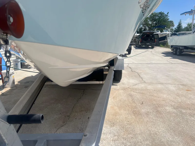 Slide: The Image of 2007 Young Boats Young 24 on trailer, viewed from below, in a sunny outdoor setting. - 27