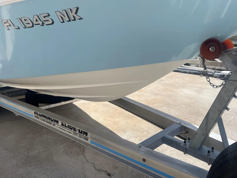 Slide: The Image of 2007 Young Boats Young 24 on trailer, partial view, with visible registration number. - 28