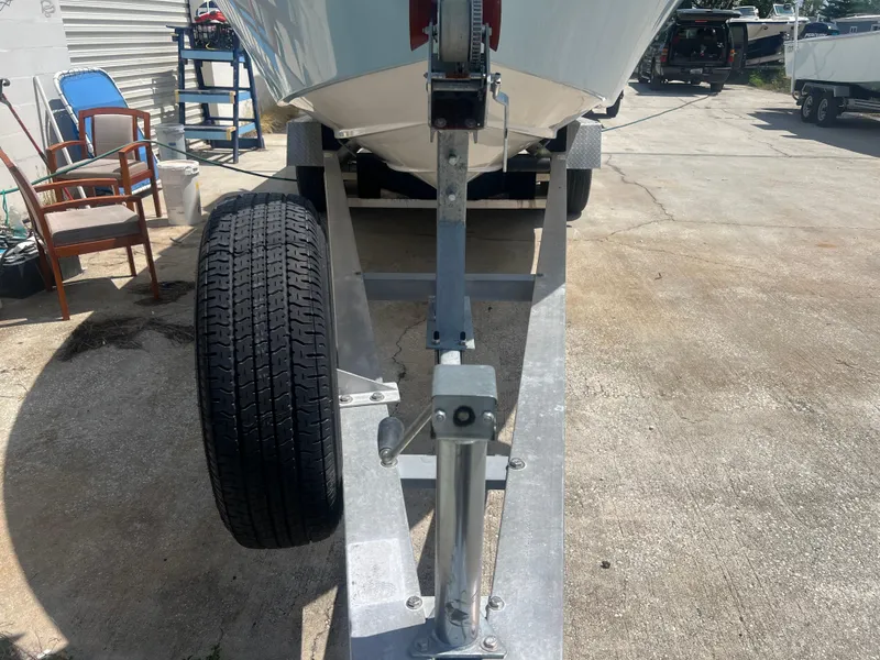 Slide: The Image of Trailer for 2007 Young Boats Young 24, featuring sturdy wheel and hitch. - 29