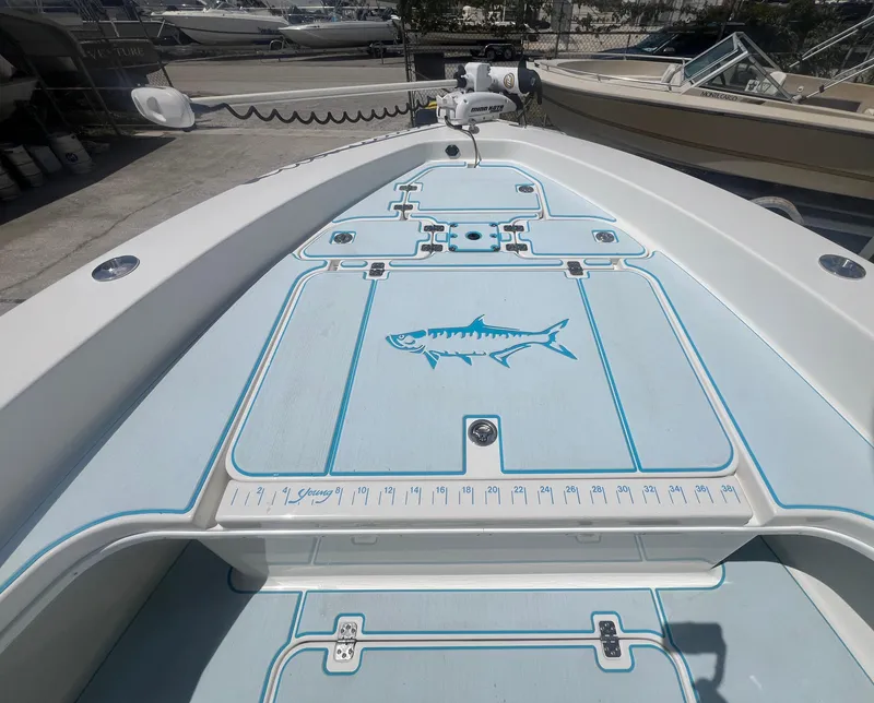 Slide: The Image of 2007 Young Boats Young 24 deck with fish graphic and measurement markings. - 3