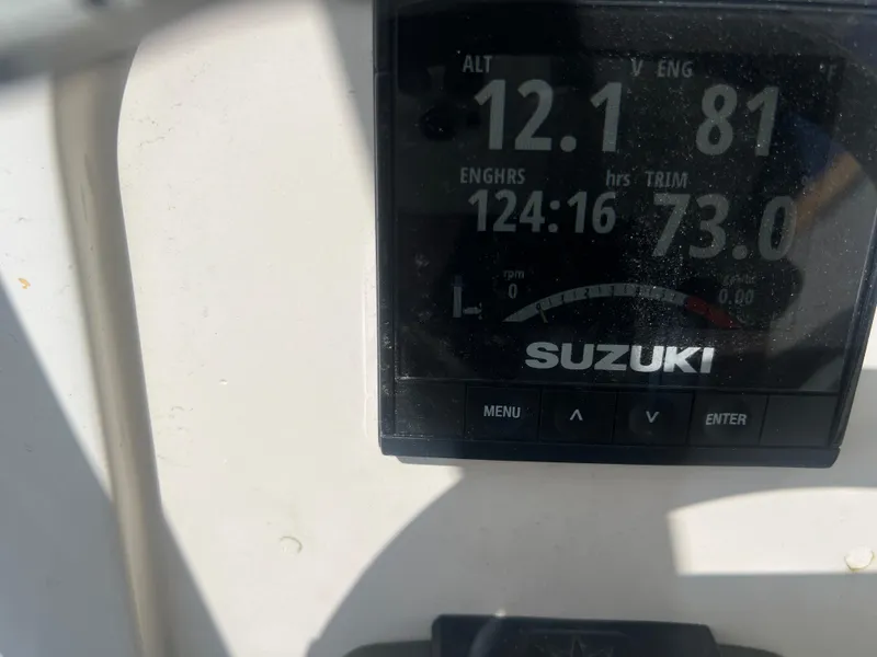 Slide: The Image of Digital display on a 2007 Young Boats Young 24, showing Suzuki engine metrics. - 30