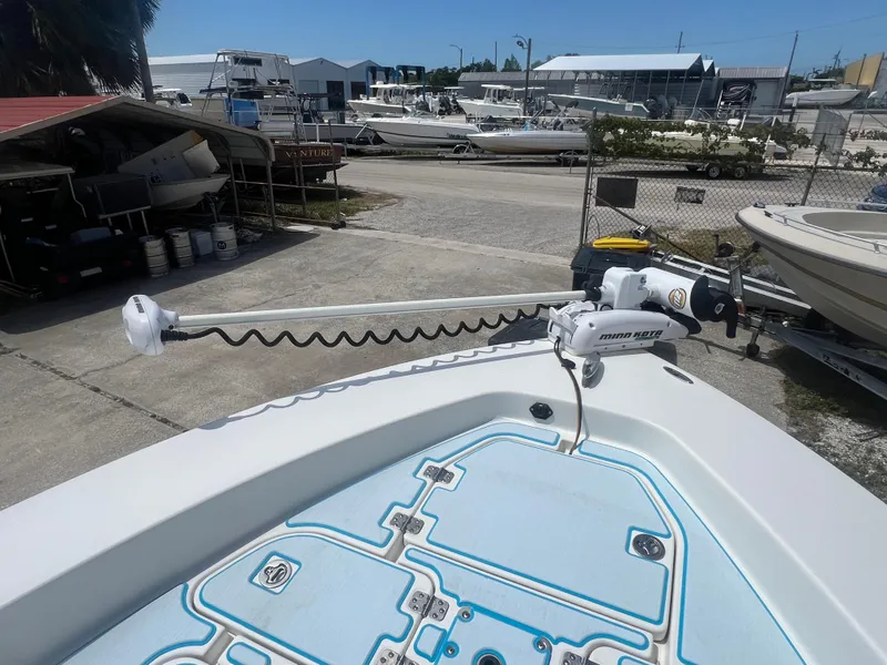 Slide: The Image of 2007 Young Boats Young 24 with trolling motor in a boatyard setting. - 4