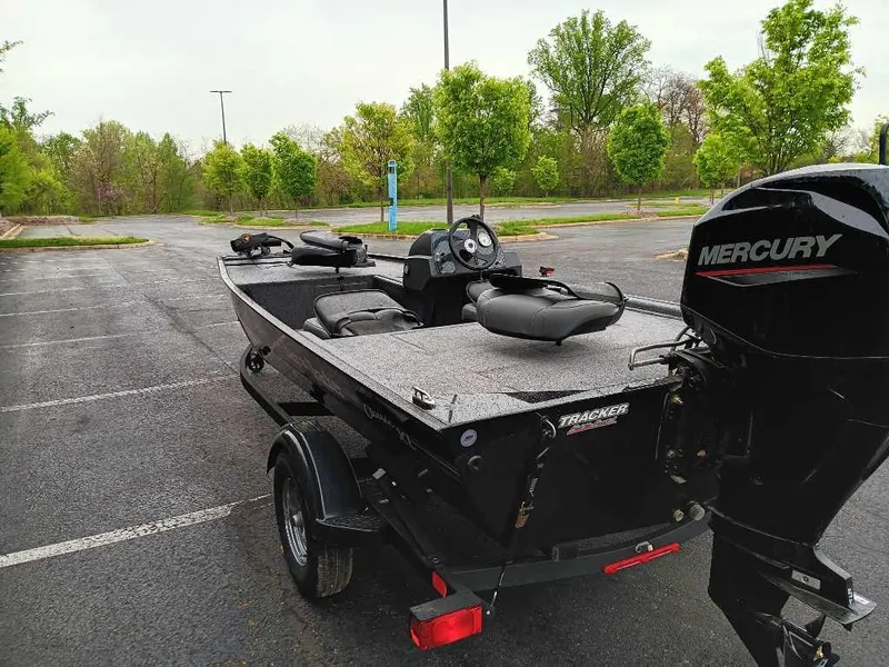 Slide: The Image of 2024 Tracker Bass Tracker Classic XL boat with Mercury engine in parking lot. - 3