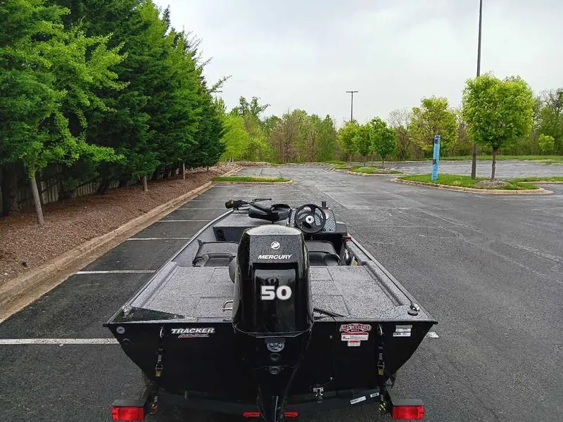 Slide: The Image of 2024 Tracker Bass Tracker Classic XL boat with Mercury 50 engine in a parking lot. - 4