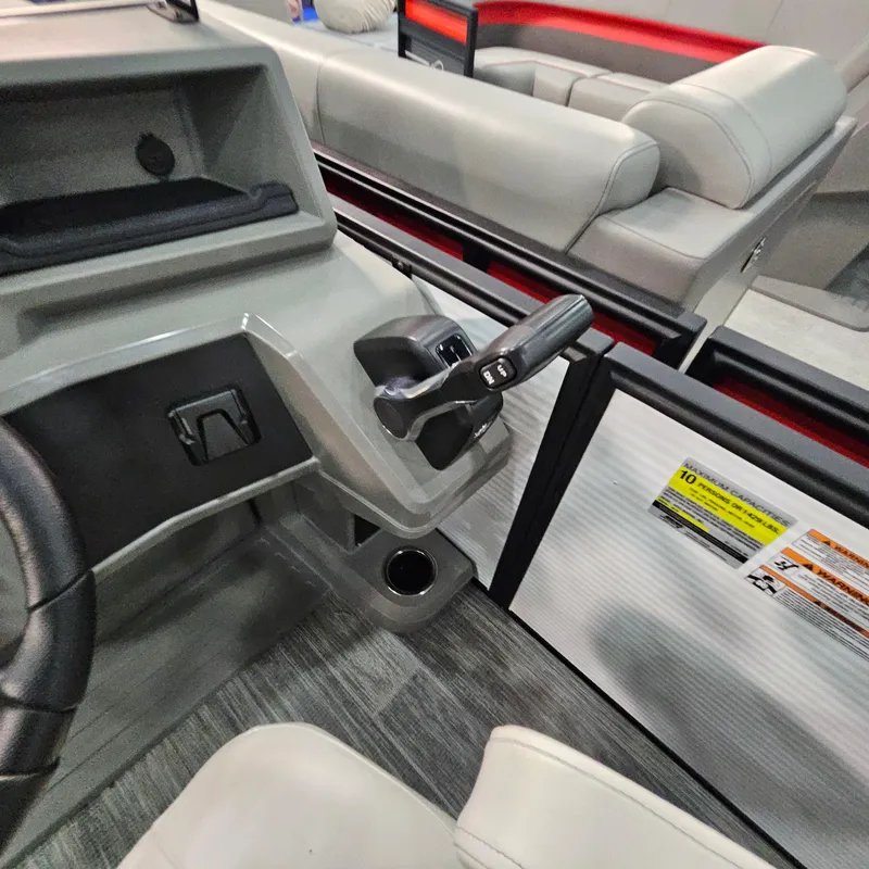 Slide: The Image of Interior of 2025 Qwest E 18 RLS boat showing steering and seating area. - 13