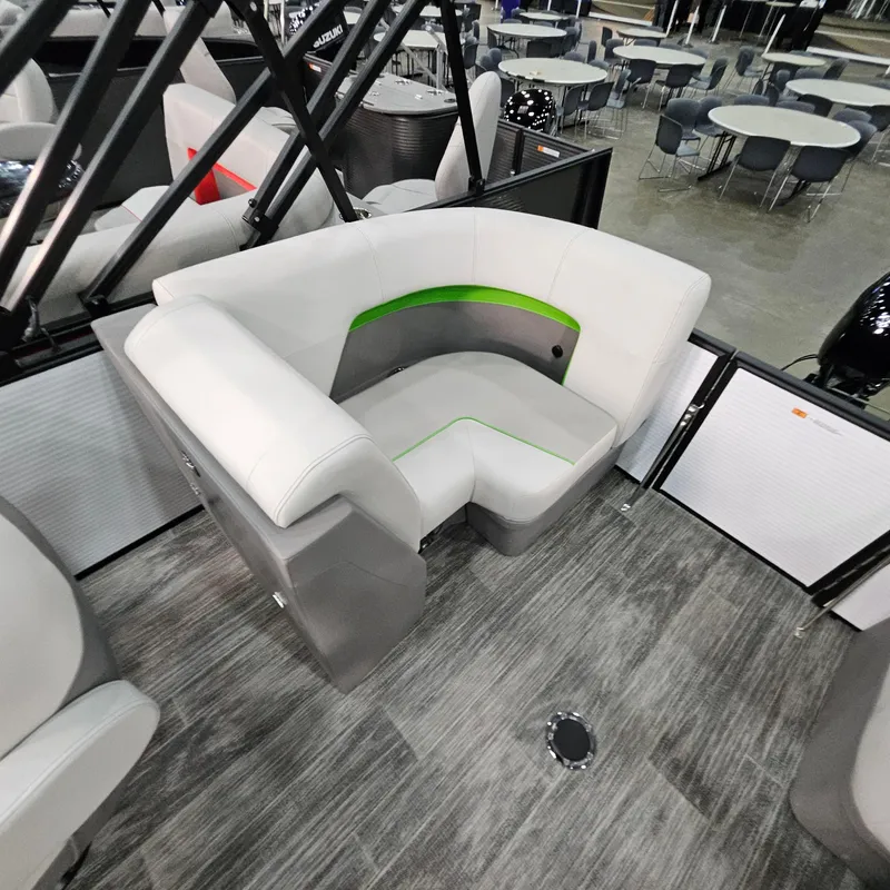 Slide: The Image of Modern seating area on 2025 Qwest E 18 RLS boat, featuring sleek design and green accents. - 17