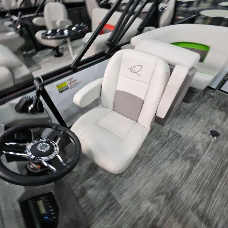 Slide: The Image of Captain's chair and steering wheel in 2025 Qwest E 18 RLS boat interior. - 9