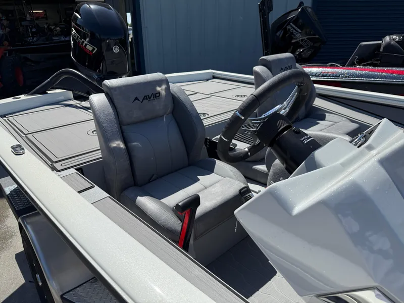 Slide: The Image of 2025 Avid 18 XB boat interior with steering wheel and seating. - 10