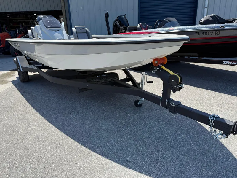 Slide: The Image of 2025 Avid 18 XB boat on trailer, parked outdoors, side view. - 3