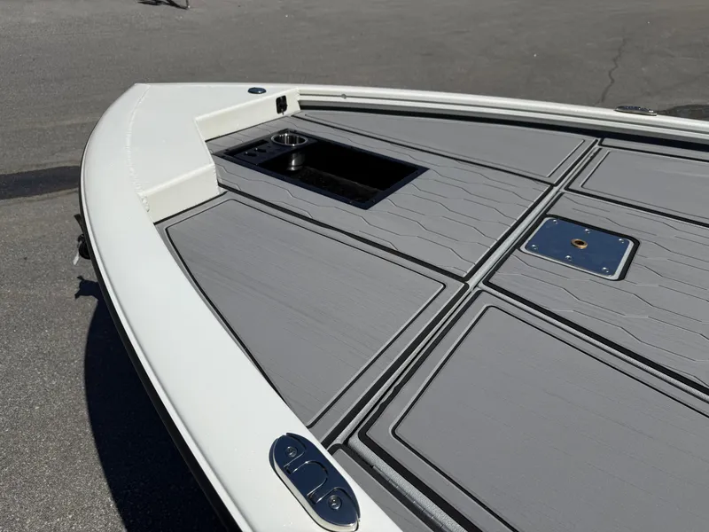 Slide: The Image of 2025 Avid 18 XB boat deck with sleek gray panels and storage compartments. - 4