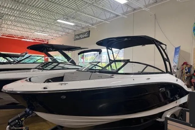 Slide: The Image of 2025 Sea Ray SPX 210 boat displayed in a showroom, featuring sleek design and modern features. - 1