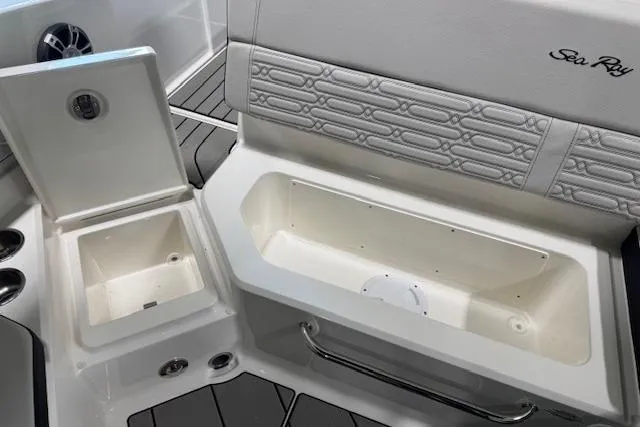 Slide: The Image of 2025 Sea Ray SPX 210 boat interior with storage compartments and stylish seating. - 12