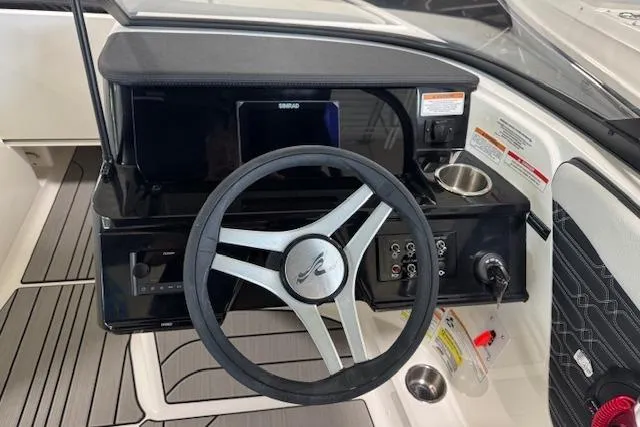 Slide: The Image of 2025 Sea Ray SPX 210 boat dashboard with steering wheel and control panel. - 4