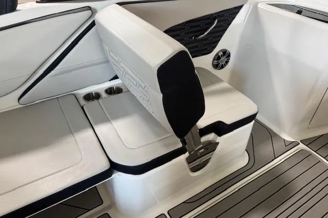 Slide: The Image of 2025 Sea Ray SPX 210 boat interior with white seating and cup holders. - 7