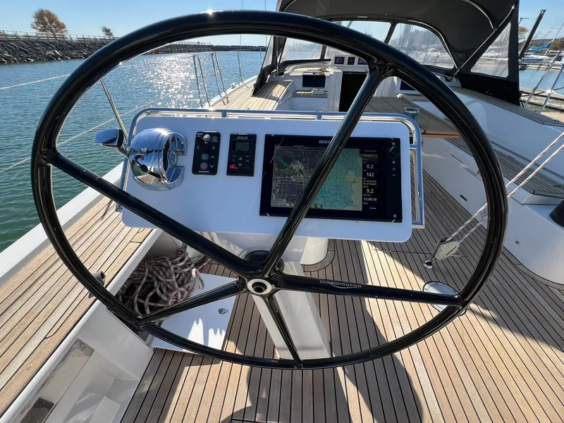 Slide: The Image of Steering wheel and navigation system on 2015 X-Yachts Xp 55 sailboat deck. - 15