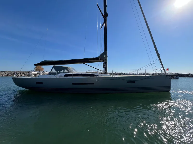 Slide: The Image of 2015 X-Yachts Xp 55 sailboat on calm water under clear blue sky. - 2