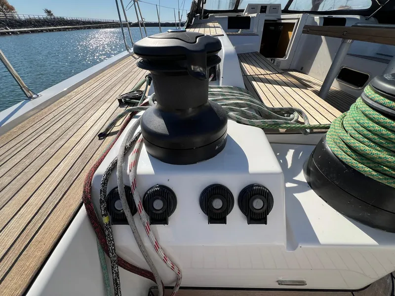 Slide: The Image of 2015 X-Yachts Xp 55 sailboat deck with winches and ropes, docked by the water. - 28