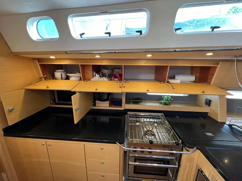 Slide: The Image of Modern kitchen in 2015 X-Yachts Xp 55 sailboat with open cabinets and sleek design. - 47
