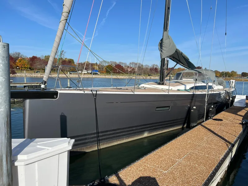 Slide: The Image of 2015 X-Yachts Xp 55 sailboat docked, sleek design, calm waters, clear sky. - 7
