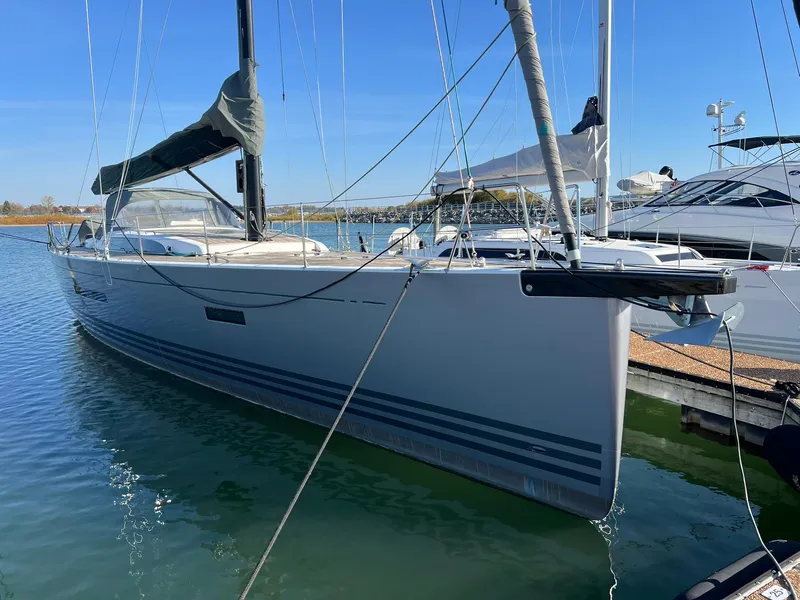 Slide: The Image of 2015 X-Yachts Xp 55 sailboat docked in marina, clear blue sky. - 8