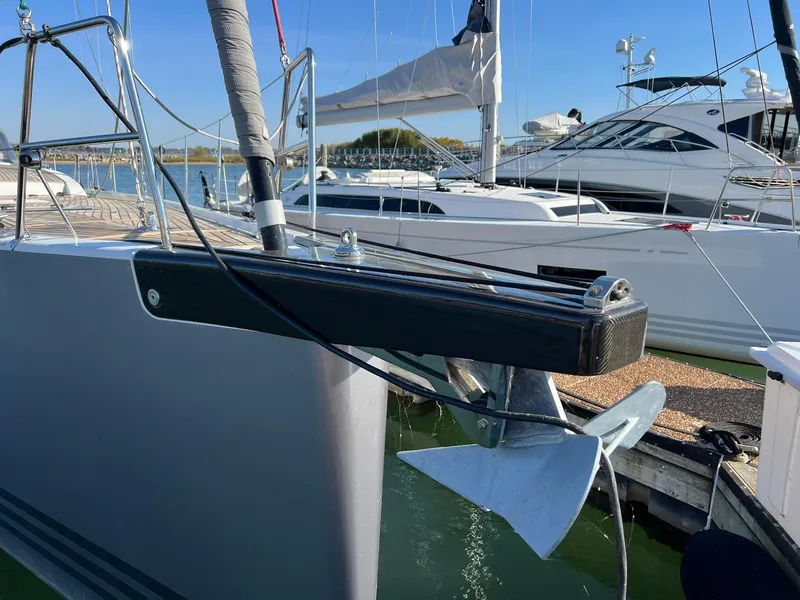 Slide: The Image of Xp 55 yacht bow with anchor, docked in marina, clear blue sky. - 9