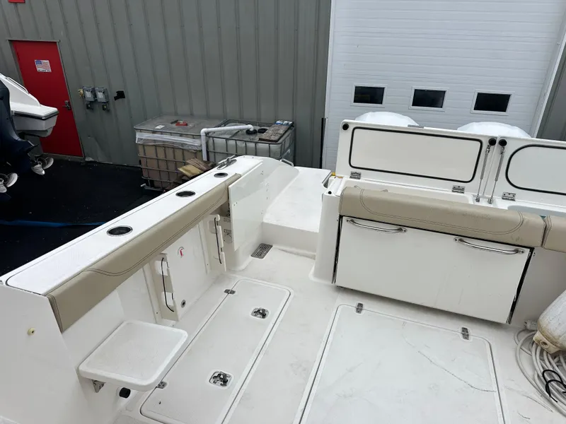 Slide: The Image of 2019 Pursuit DC 325 boat interior with seating and storage compartments. - 14
