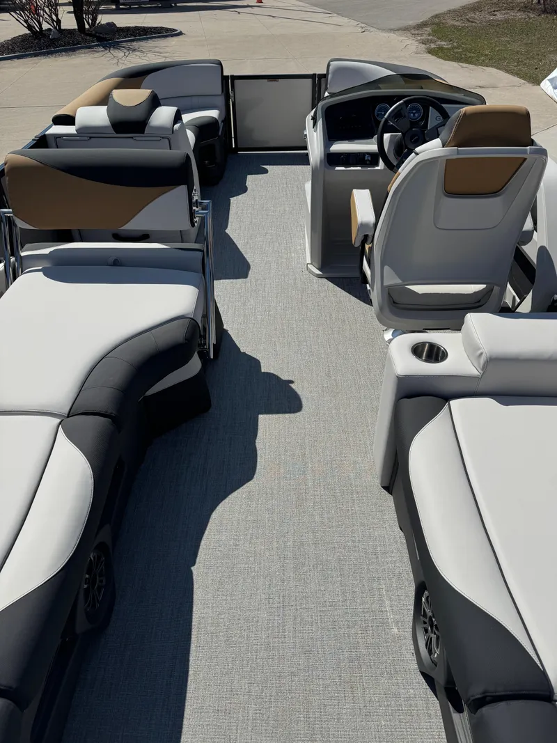 Slide: The Image of 2025 Tahoe Pontoon LTZ Quad Lounger Shift interior with modern seating and steering console. - 8