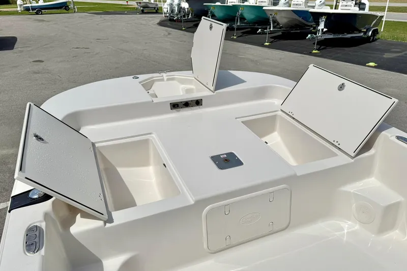 Slide: The Image of 2025 Carolina Skiff 21 LS boat with open storage compartments on deck. - 11
