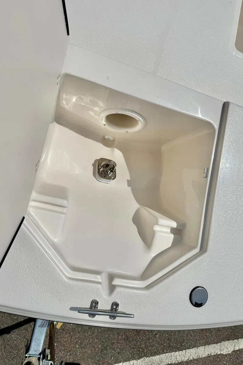 Slide: The Image of 2025 Carolina Skiff 21 LS boat storage compartment, open and empty. - 12