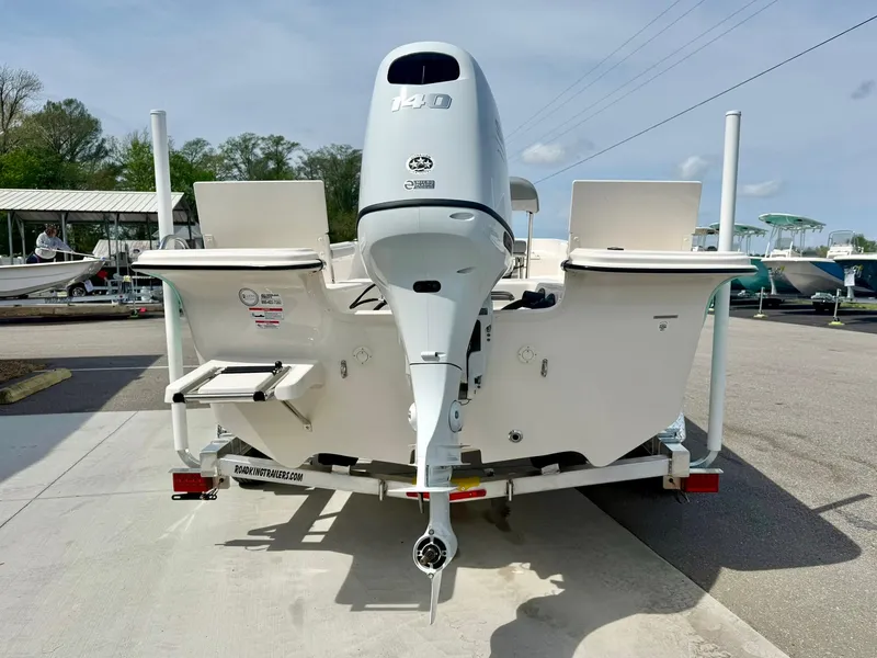 Slide: The Image of 2025 Carolina Skiff 21 LS boat on trailer, rear view with outboard motor. - 2