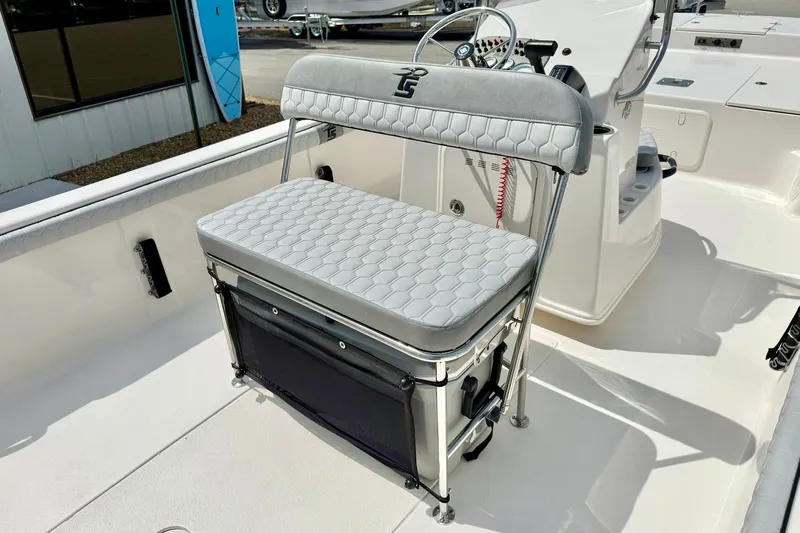 Slide: The Image of 2025 Carolina Skiff 21 LS boat interior with cushioned seating and steering console. - 24