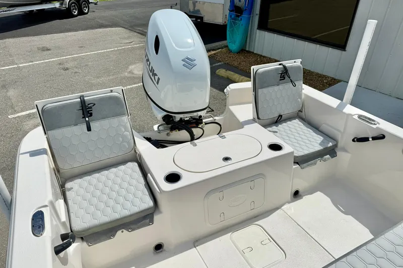 Slide: The Image of 2025 Carolina Skiff 21 LS boat interior with seating and outboard motor. - 29