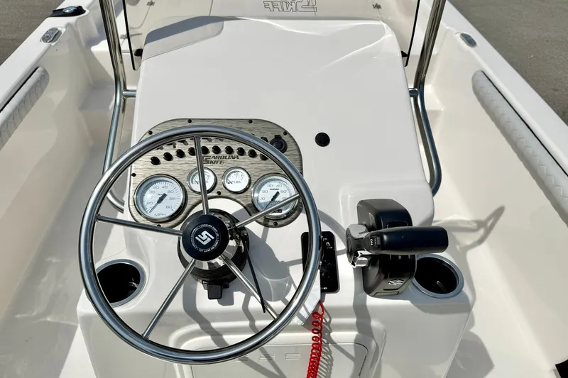 Slide: The Image of 2025 Carolina Skiff 21 LS boat console with steering wheel and gauges. - 3