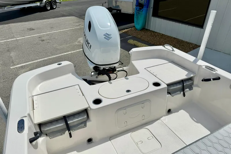 Slide: The Image of 2025 Carolina Skiff 21 LS boat with Suzuki outboard motor, featuring spacious deck and storage compartments. - 30