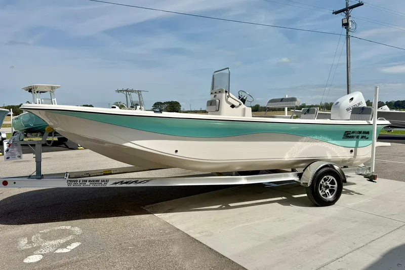 Slide: The Image of 2025 Carolina Skiff 21 LS boat on trailer, displayed outdoors under clear sky. - 5