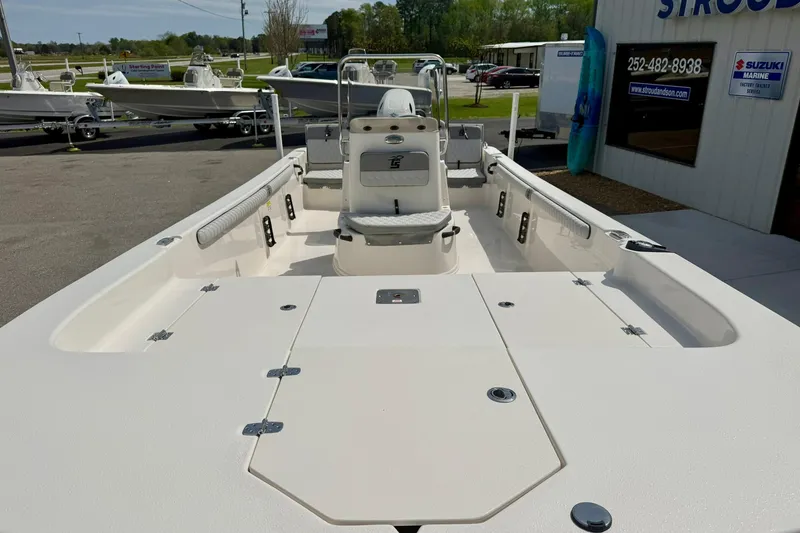 Slide: The Image of 2025 Carolina Skiff 21 LS boat, spacious deck, white interior, outdoor showroom display. - 9
