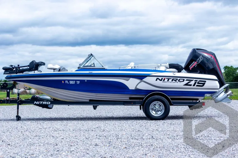 Slide: The Image of 2022 Nitro Z19 Sport boat on trailer, blue and white design, parked outdoors. - 16