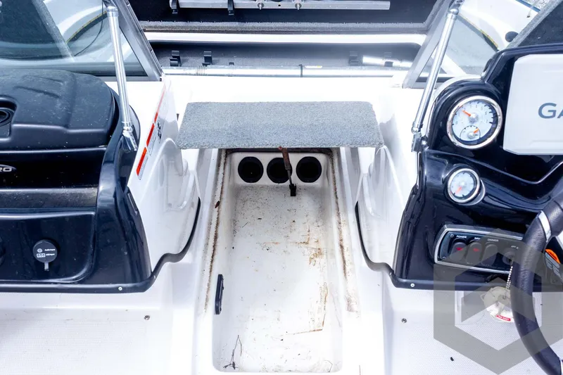 Slide: The Image of 2022 Nitro Z19 Sport boat interior with storage compartment and control panel. - 24