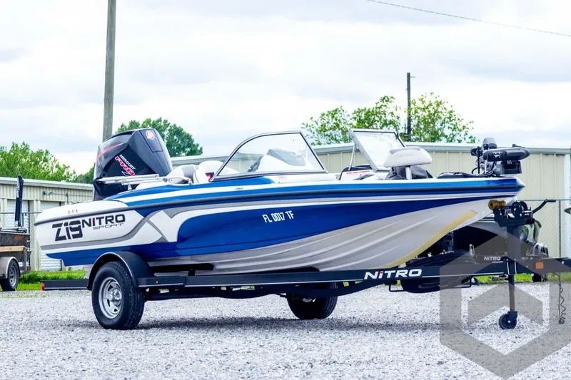 Slide: The Image of 2022 Nitro Z19 Sport boat on trailer, blue and white design, parked outdoors. - 3