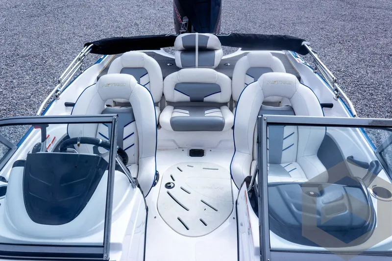 Slide: The Image of 2022 Nitro Z19 Sport boat interior with white and gray seating, dual consoles, and spacious layout. - 32