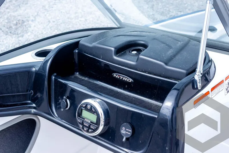 Slide: The Image of Dashboard of a 2022 Nitro Z19 Sport boat with control panel and storage. - 40