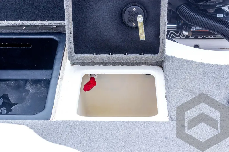 Slide: The Image of 2022 Nitro Z19 Sport boat storage compartment with open hatch and red valve. - 43