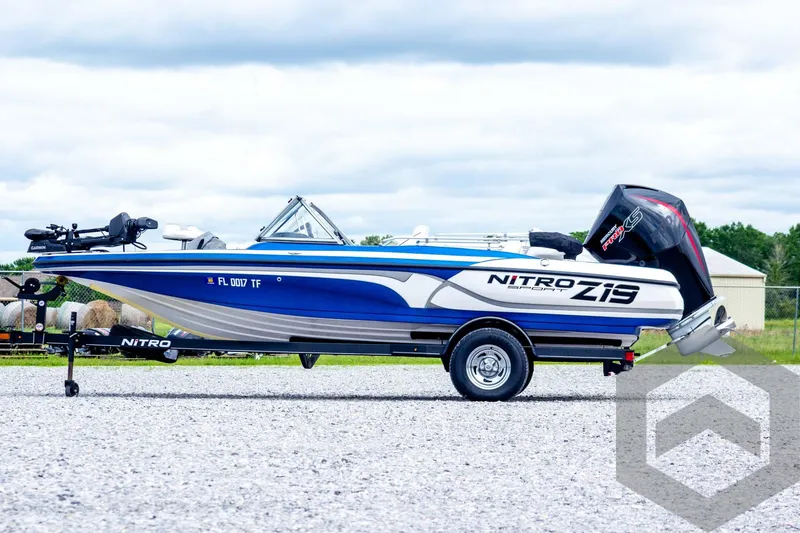 Slide: The Image of 2022 Nitro Z19 Sport boat on trailer, blue and white design, parked outdoors. - 8