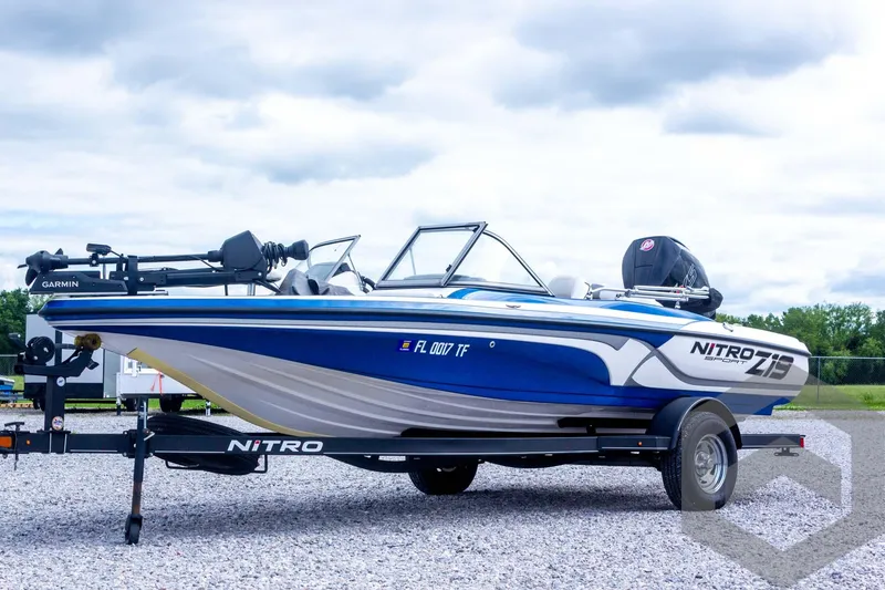 Slide: The Image of 2022 Nitro Z19 Sport boat on trailer, blue and white design, parked outdoors. - 9