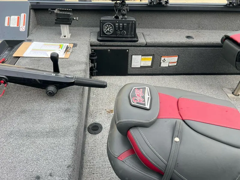 Slide: The Image of 2022 Ranger VS1665T boat interior with gray and red seating, control panel, and equipment. - 4