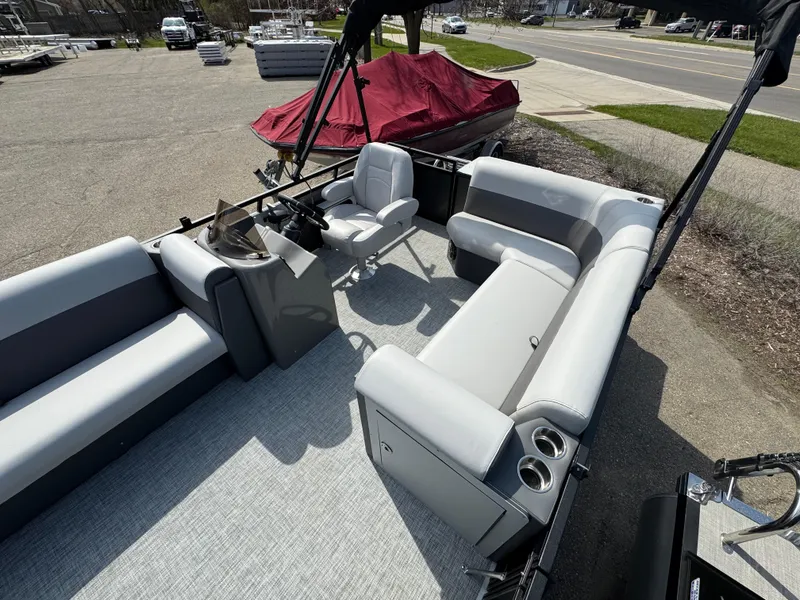 Slide: The Image of 2025 Qwest E 20 Lanai pontoon boat interior with gray seating and steering console. - 12