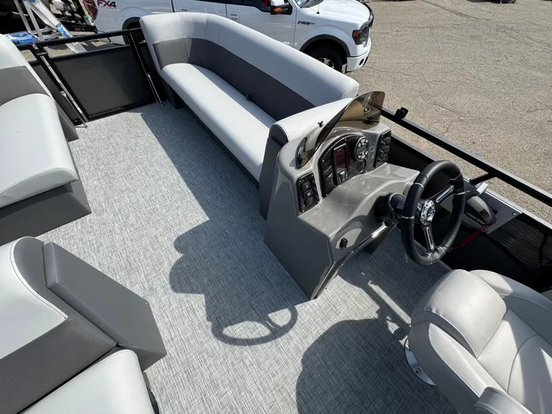 Slide: The Image of 2025 Qwest E 20 Lanai boat interior with steering console and seating. - 13