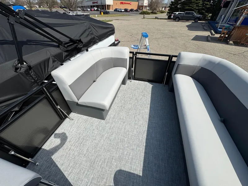 Slide: The Image of 2025 Qwest E 20 Lanai boat interior with gray seating and carpeted floor. - 14